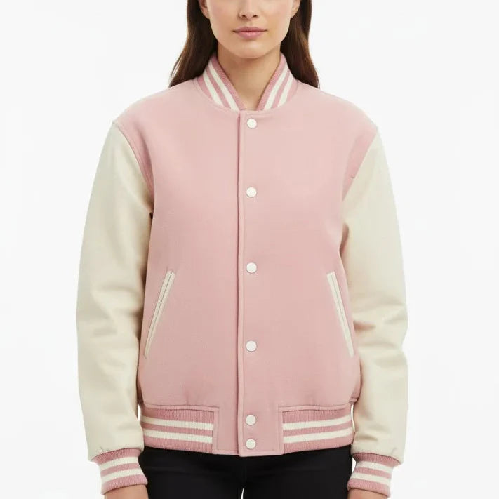 Person wearing a pink and cream varsity jacket on a white background