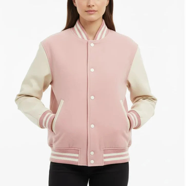 Woman wearing a pink and white varsity jacket on a white background