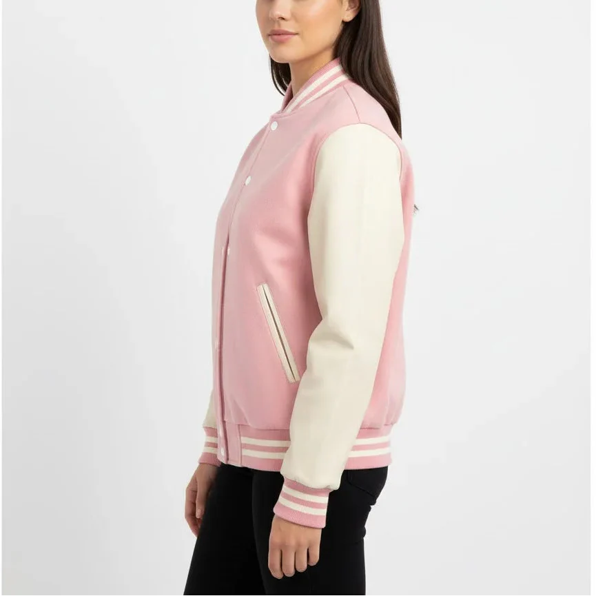 Woman wearing a pink and white varsity jacket on a white background