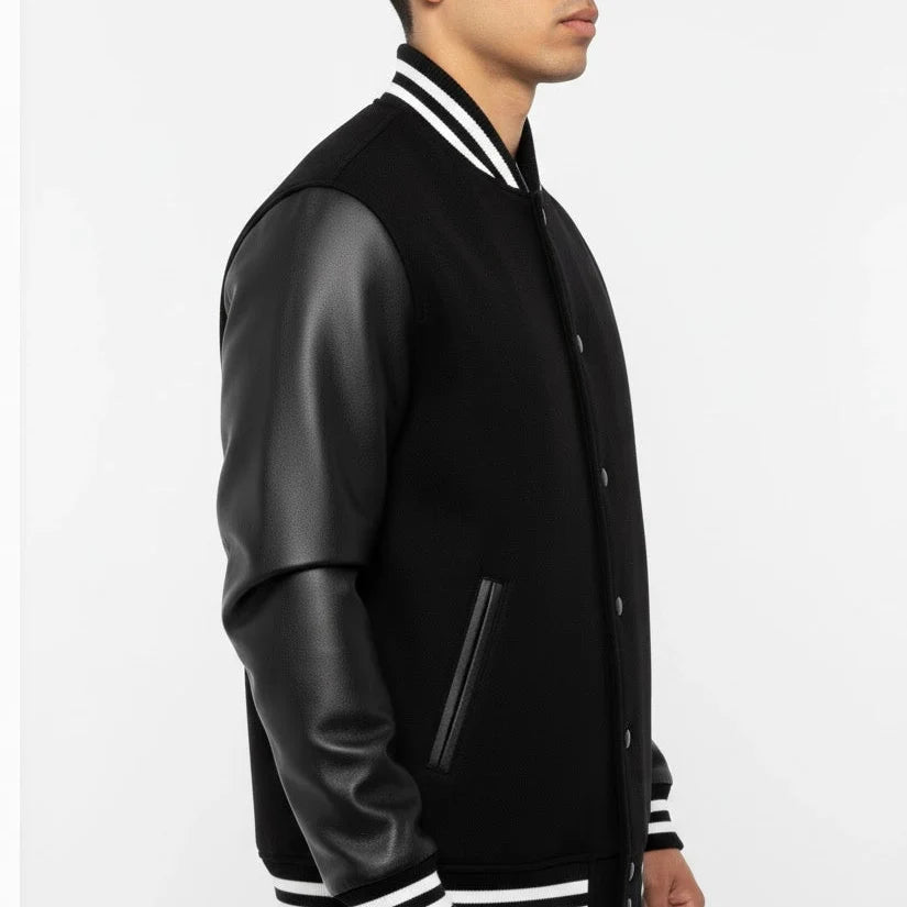 Black varsity jacket with leather sleeves on a white background