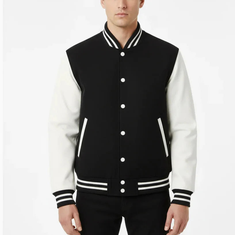 Man wearing a black and white varsity jacket on a white background