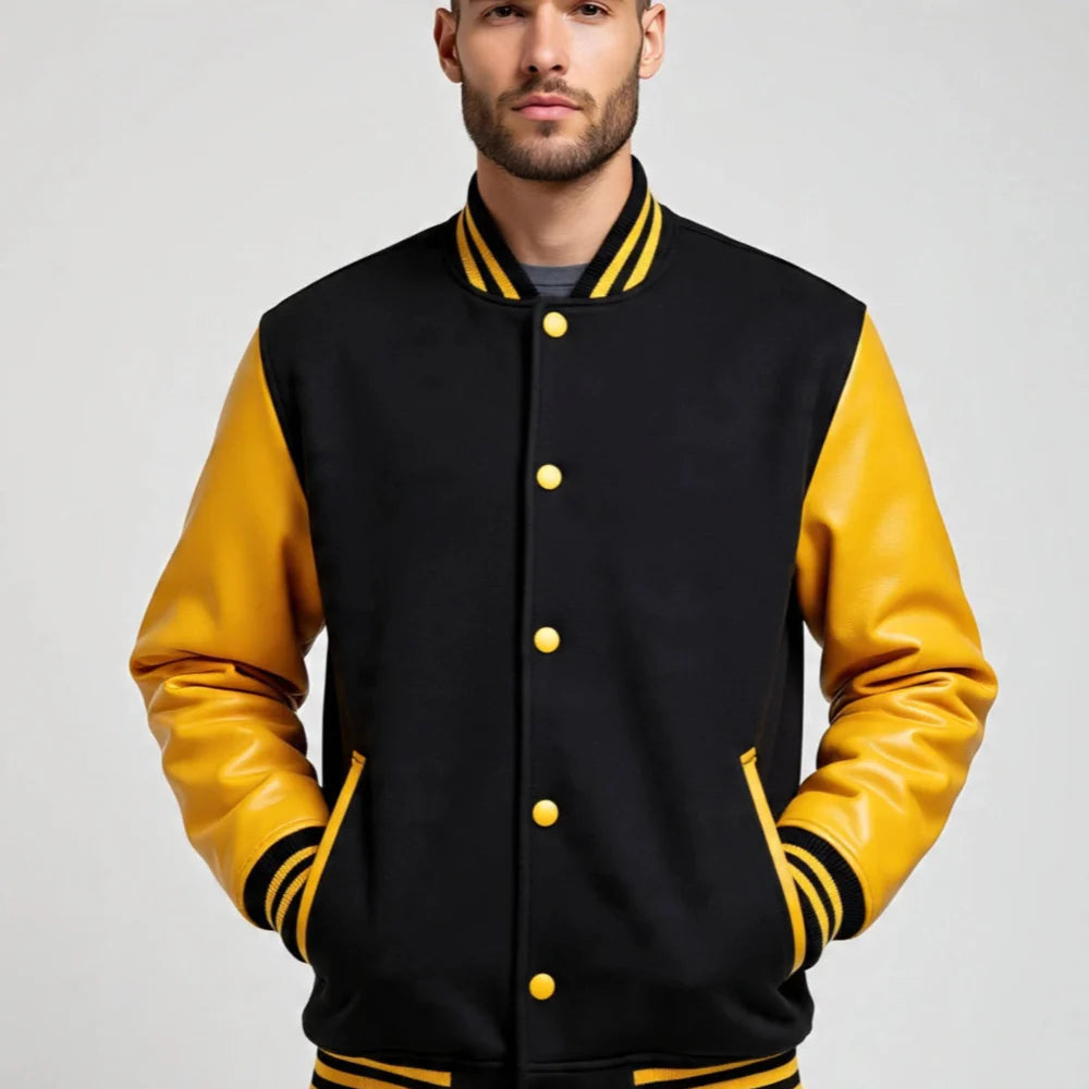 Man wearing a black and yellow varsity jacket on a gray background